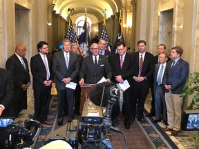 South Carolina Gov. Henry McMaster stands with several legislators to talk about the states efforts to get the Carolina Panthers a new practice facility, Wednesday, March 13, 2019, in Columbia, S.C. Lawmakers will try to pass a bill making football players full-time workers under state law so the Panthers could get t tax credits.