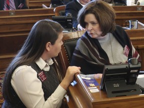 Kansas state Reps. Stephanie Clayton, left, D-Overland Park, and Kathy Wolfe Moore, right, D-Kansas City, confer before a House vote on a resolution condemning a new New York law protecting abortion rights, Wednesday, March 13, 2019, at the Statehouse in Topeka, Kansas. Clayton opposed the resolution, while Wolfe Moore was one of only two Democrats to support it.