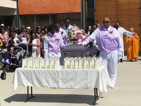 Mourners attend the funeral service of Trinity Love Jones, the 9-year-old whose body was found this month stuffed in a duffel bag along an equestrian trail, at St. John Vianney Catholic Church in Hacienda Heights, Calif., Monday, March 25, 2019. The Hacienda Heights community where her body was found had embraced the child in death during the days she remained unidentified. A park worker found Trinity on March 5. A huge memorial sprang up at the site as community members heard about the case. She was identified the following weekend and prosecutors have since filed murder charges against her mother and the mother's boyfriend.