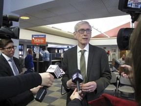 Wisconsin Gov. Tony Evers speaks to reporters Monday, March 25, 2019, in Madison, Wis. Evers moved quickly after last week's order to rescind 82 of former Republican Gov. Scott Walker's appointments that the state Senate confirmed during the lame-duck session. And Attorney General Josh Kaul, at Evers' order, moved to withdraw Wisconsin from a multi-state lawsuit seeking repeal of the Affordable Health Care Act, a power taken away from him during the lame-duck session.