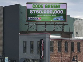 A billboard promotes an estimated $750 million Powerball jackpot in downtown Des Moines, Iowa, Wednesday, March 27.2019.