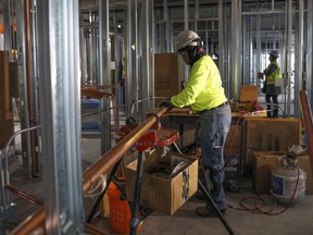 In this Jan. 24, 2019, photo, Zakiyyah Askia installs plumbing at a high rise residence under construction in Chicago. The federal Bureau of Labor Statistics says women still represent only 3.4 percent of the nation's 8.3 million construction workers, but that's an improvement over 2.5 percent a decade ago.