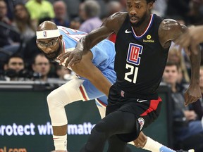 Sacramento Kings guard Corey Brewer, left, and Los Angeles Clippers guard Patrick Beverley, right, chase the ball during the first quarter of an NBA basketball game in Sacramento, Calif., Friday, March 1, 2019.