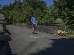 A person walks their dog on Overtoun Bridge in Dumbarton, Scotland on June 30, 2018.