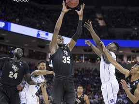 Central Florida forward Collin Smith (35) grabs a rebound next to Duke forward Zion Williamson, right, during the first half of a second-round game in the NCAA men's college basketball tournament Sunday, March 24, 2019, Columbia, S.C.