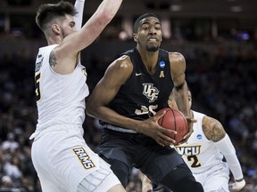 Central Florida forward Collin Smith (35) drives to the basket against VCU forward Sean Mobley (5) during the first half of a first-round game in the NCAA men's college basketball tournament Friday, March 22, 2019, in Columbia, S.C.