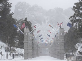 Blowing snow reduces visibility at the Mount Rushmore National Memorial near Keystone, S.D., Wednesday, March 13, 2019. A window-rattling storm brought blizzards, floods and a tornado across more than 25 states Wednesday, stretching from the northern Rocky Mountains to Texas and beyond.
