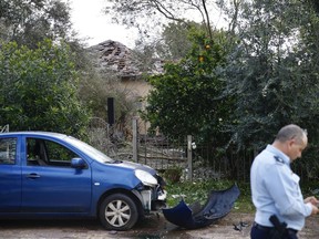 Damage to a house hit by a rocket is seen in Mishmeret, central Israel, Monday, March 25, 2019. An early morning rocket from the Gaza Strip struck a house in central Israel on Monday, wounding several people, an Israeli rescue service said, in an eruption of violence that could set off another round of violence shortly before the Israeli election.