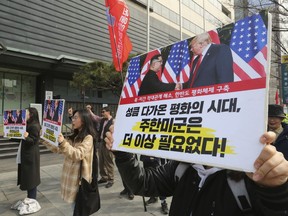 In this March 2, 2019, photo, South Korean protesters with banners showing photos of U.S. President Donald Trump and North Korean leader Kim Jong Un stage a rally to denounce policies of the United States on North Korea in Seoul, South Korea. North Korean leader Kim will soon make a decision on whether to continue diplomatic talks and maintain the country's moratorium on missile launches and nuclear tests, a senior North Korean official said on Friday, March 15, 2019, noting the U.S. threw away a golden opportunity at the recent summit between their leaders. The signs read: "No need the US-South Korea alliance."