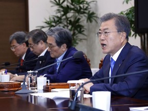 South Korean President Moon Jae-in, right, presides over a meeting of the National Security Council at the presidential Blue House in Seoul, South Korea, Monday, March 4, 2019. Moon said Seoul will actively try to get the nuclear negotiations between Washington and Pyongyang quickly back on track.