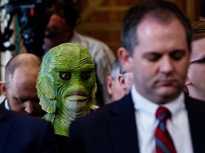 A Greenpeace protester wearing a mask listens during a confirmation hearing for David Bernhardt, U.S. secretary of interior nominee on Thursday, March 28, 2019. Bernhardt's Senate