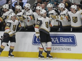 Vegas Golden Knights center William Karlsson (71) is congratulated by teammates after scoring a goal against the San Jose Sharks during the first period of an NHL hockey game in San Jose, Calif., Monday, March 18, 2019.