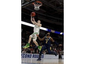 Oregon guard Payton Pritchard drives to the basket past UC Irvine guard Max Hazzard during the first half of a second-round game in the NCAA men's college basketball tournament Sunday, March 24, 2019, in San Jose, Calif.