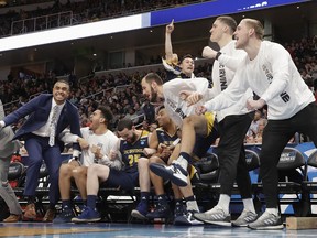 UC Irvine players and coaches celebrate during the second half of a first round men's college basketball game against Kansas State in the NCAA Tournament, Friday, March 22, 2019, in San Jose, Calif.