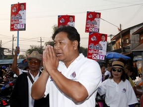 In this March 14, 2019, photo, Veerawit Chuajunud, center, who changed his name to Thaksin Chuajunud for Pheu Chart party, makes his election campaign in Nakhon Ratchasima, Thailand. Thailand's former Prime Minister Thaksin Shinawatra is in exile and banned from interfering in the country's politics. But his name is a powerful political attraction and in tribute, and to win votes, some candidates in general election on Sunday, March 24, 2019 have changed their names to Thaksin so supporters of the former leader can register their loyalty at the ballot box.