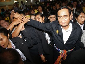 Locals shake the hands of Prime Minister Prayuth Chan-ocha and candidate for the same position, during a government-sponsored event in Nakhon Ratchasima, Thailand, Wednesday, March 13, 2019. Prayuth has been nominated by a pro-army political party to become prime minister again after the March 24 general election.