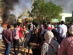 FILE - In this Jan. 13, 2019 file photo, anti-government protesters rally in Khartoum, Sudan. Three months after Sudanese protesters rose up against President Omar al-Bashir, the longtime autocrat has bound himself more tightly to the military and refused to bow to their demands. Al-Bashir has remained in power through three decades of war and sanctions, the secession of Sudan's oil-rich south in 2011 and an international arrest warrant for genocide and war crimes linked to the Darfur conflict. (AP Photo, File)