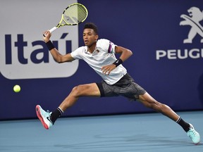 Felix Auger-Aliassime, of Canada, runs down a shot from Borna Coric, of Croatia, during the quarterfinals of the Miami Open tennis tournament Wednesday, March 27, 2019, in Miami Gardens, Fla.
