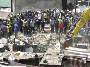 In this image taken from video rescue workers and emergency teams work at the scene of a building collapse in Lagos, Nigeria, Wednesday March 13, 2019. There was no immediate official word on numbers of casualties. (AP Photo)