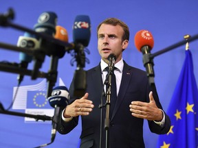 FILE - In this Sunday, June 24, 2018 file photo French President Emmanuel Macron speaks with the media at the conclusion of an informal EU summit on migration at EU headquarters in Brussels.