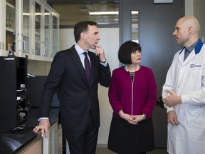 Bill Morneau, Minister of Finance, left, and Ginette Petitpas Taylor, federal Minister of Health, tour a wet lab led by Gaspard Montandon before speaking at a press conference on the national pharmacare program at the Li Ka Shing Knowledge Institute in Toronto on Wednesday, March 6, 2019.