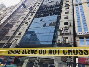 CORRECTS PHOTOGRAPHER'S NAME - A high-rise office building damaged by Thursday's fire is pictured in Dhaka, Bangladesh Friday, March 29, 2019. A Bangladeshi housing official said Friday criminal charges would be filed against the owner of the building where a fire killed dozens of people and which had four upper floors constructed illegally.