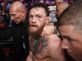 FILE - In this Oct. 6, 2018, file photo, Conor McGregor walks out of the arena after he was defeated by Khabib Nurmagomedov in a lightweight title mixed martial arts bout at UFC 229 in Las Vegas. Superstar UFC fighter McGregor has announced on social media that he is retiring from mixed martial arts. McGregor's verified Twitter account had a post early Tuesday, March 26, 2019,  that said the former featherweight and lightweight UFC champion was making a "quick announcement."