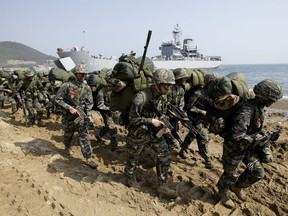 FILE - In this March 30, 2015, file photo, South Korean Marines march after landing on the beach during the U.S.-South Korea joint landing military exercises as a part of the annual joint military exercise Foal Eagle between South Korea and the United States in Pohang, South Korea. South Korea and the U.S. say they've decided to end their springtime military drills to back diplomacy with North Korea.