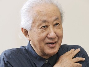 In this photo taken in 2013, architect Arata Isozaki is interviewed. Isozaki, credited with bringing together the East and West in his innovative designs, has been awarded this year's Pritzker Architecture Prize, known internationally as the highest honor in the field. The 2019 prize was announced Tuesday, March 5, 2019. (Kyodo News via AP)