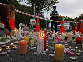 A student lights candle during a vigil to commemorate victims of March 15 shooting, outside the Al Noor mosque in Christchurch, New Zealand.