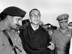 FILE -  In this April 18, 1959, file photo, Tibetan spiritual leader the Dalai Lama, center,  arrives at Tezpur, Assam in India. Tibetan activists put up posters and hoisted a Tibetan flag in India's capital New Delhi on Sunday, March 10, 2019, to mark the 60th anniversary of 1959 uprising against Chinese rule. (AP Photo, File)