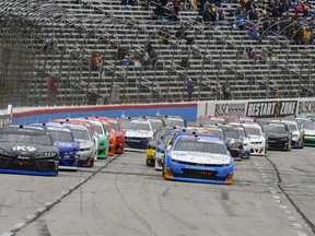 Kyle Busch, left, and Tyler Reddick, right, lead the field during a restart of a NASCAR auto race at Texas Motor Speedway, Saturday, March 30, 2019, in Fort Worth, Texas.