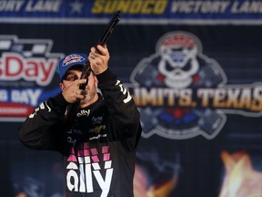 Jimmie Johnson (48) aims a rifle in victory lane after taking the pole position for the NASCAR Cup Series auto race at Texas Motor Speedway in Fort Worth, Texas, Friday, March 29, 2019.