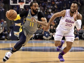 Memphis Grizzlies guard Mike Conley (11) handles the ball against Minnesota Timberwolves guard Josh Okogie (20) in the first half of an NBA basketball game Saturday, March 23, 2019, in Memphis, Tenn.