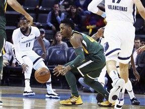 Utah Jazz's Donovan Mitchell (45) goes after a loose ball while defended by Memphis Grizzlies' Mike Conley (11) and others during the first half of an NBA basketball game Friday, March 8, 2019, in Memphis, Tenn.