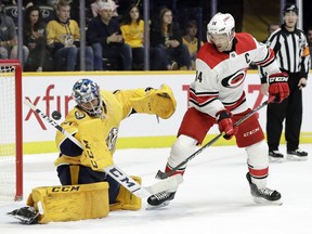 Carolina Hurricanes right wing Justin Williams (14) watches as a shot by teammate Nino Niederreiter gets past Nashville Predators goaltender Juuse Saros, of Finland, for a goal in the first period of an NHL hockey game Saturday, March 9, 2019, in Nashville, Tenn.