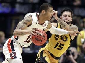 Auburn guard Samir Doughty (10) drives against Missouri guard Jordan Geist (15) in the first half of an NCAA college basketball game at the Southeastern Conference tournament Thursday, March 14, 2019, in Nashville, Tenn.