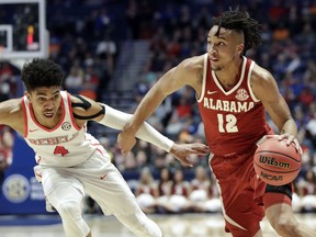 Alabama guard Dazon Ingram (12) drives against Mississippi guard Breein Tyree (4) in the first half of an NCAA college basketball game at the Southeastern Conference tournament Thursday, March 14, 2019, in Nashville, Tenn.