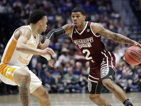 Mississippi State guard Lamar Peters (2) drives against Tennessee's Lamonte Turner (1) in the first half of an NCAA college basketball game at the Southeastern Conference tournament Friday, March 15, 2019, in Nashville, Tenn.