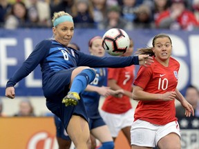 United States midfielder Julie Ertz (8) kicks the ball down field as England forward Fran Kirby (10) moves in during the first half of a SheBelieves Cup women's soccer match Saturday, March 2, 2019, in Nashville, Tenn.
