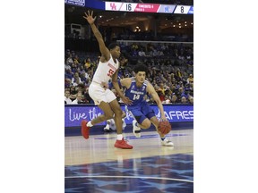 Memphis' Isaiah Maurice drives the ball past Houston's Brinson Gresham in the first half of an NCAA college basketball game at the American Athletic Conference tournament Saturday, March 16, 2019, in Memphis, Tenn.