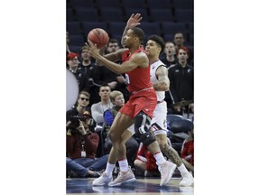SMU guard Jarrey Foster is defended by Cincinnati's Jarron Cumberland during the first half of an NCAA college basketball game at the American Athletic Conference men's tournament Friday, March 15, 2019, in Memphis, Tenn.