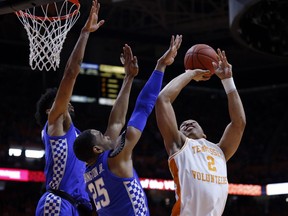 Tennessee forward Grant Williams (2) shoots as as Kentucky forward PJ Washington (25) and forward Nick Richards (4) defend during the first half of an NCAA college basketball game Saturday, March 2, 2019, in Knoxville, Tenn.
