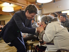 Prime Minister Justin Trudeau is greeted by an Inuit Elder before delivering an official apology to the Inuit in Iqaluit, Nunavut on Friday, March 8, 2019.