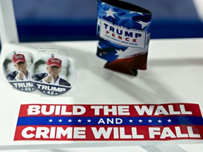 A "Build The Wall And Crime Will Fall" sticker sits on display at a both during the Conservative Political Action Conference (CPAC) in National Harbor, Maryland, U.S., on Friday, March 1, 2019.