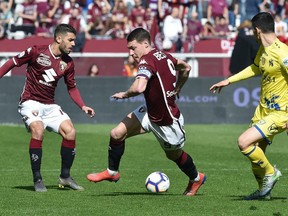Torino's Andrea Belotti, center, controls the ball during a Serie A soccer match between Torino and Chievo Verona, at the Olimpico Grande Torino stadium in Turin, Italy, Sunday, March 3, 2019.