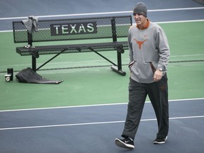 In this January 2018 photo, Texas men's tennis coach Michael Center surveys the courts before the matches with UTSA, in Austin, Texas. Center is among a few people in the state charged in a scheme that involved wealthy parents bribing college coaches and others to gain admissions for their children at top schools, federal prosecutors said Tuesday, March 12, 2019.