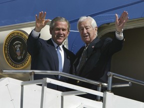 FILE - In this March 8, 2004, file photo, then President Bush, left, waves with Rep. Ralph Hall, R-Texas, right, as they step off Air Force One upon Bush's arrival in Dallas. Former Rep. Hall, the oldest-ever member of the U.S. House, has died at age 95.