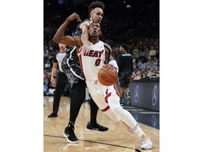 Miami Heat's Josh Richardson (0) is fouled by San Antonio Spurs' Derrick White during the first half of an NBA basketball game Wednesday, March 20, 2019, in San Antonio.