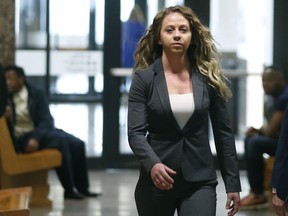 Former Dallas Police officer Amber Guyger walks the hallway on her third court appearance at the Frank Crowley Courts Building in Dallas on Monday, March 18, 2019. Guyger is charged with murder in the September 2018 shooting death of Botham Jean, an unarmed black man who she fatally shot after entering his apartment.